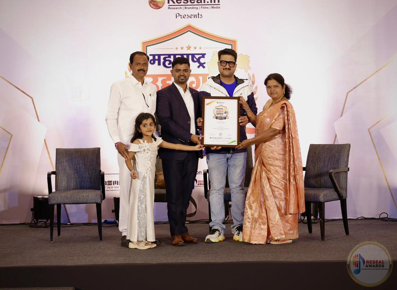 The Vastukala Associates team receiving the Maharashtra Udyog Bhushan Award 2026 on stage at the Hyatt Hotel, Pune
